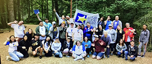 A large group of people posing while at summer camp.